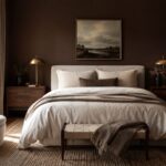 Chocolate brown bedroom with ivory bedding, warm wood furniture, and brass lamps